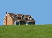 picture of a house in a green field